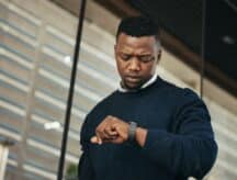 A man checking the time on his wristwatch.