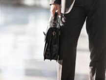 A shot of a hand holding a briefcase.