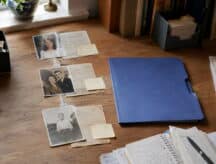 A busy desk with documents assembled for a proof of citizenship application.