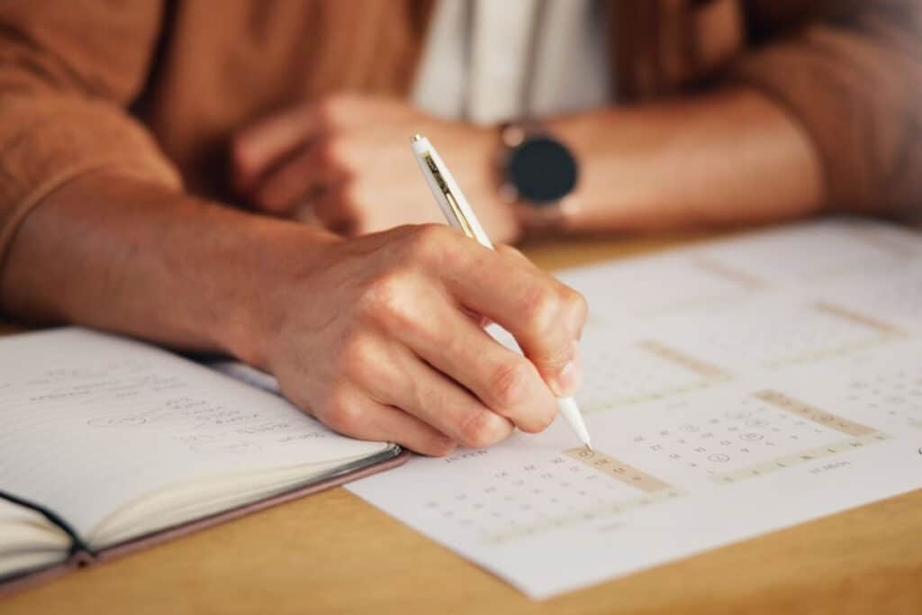 Closeup shot of a man's hands, checking calendar.