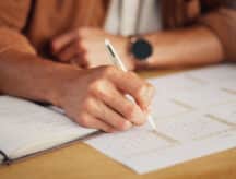 Closeup shot of a man's hands, checking calendar.