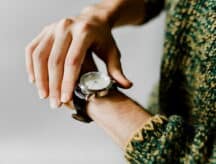 Closeup shot of someone checking their watch.