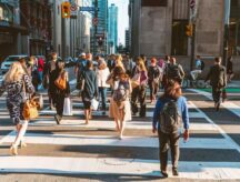 People walking across the street in Toronto, Ontario.