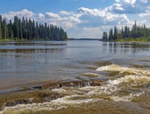 A river in Manitoba with some surrounding scenery.